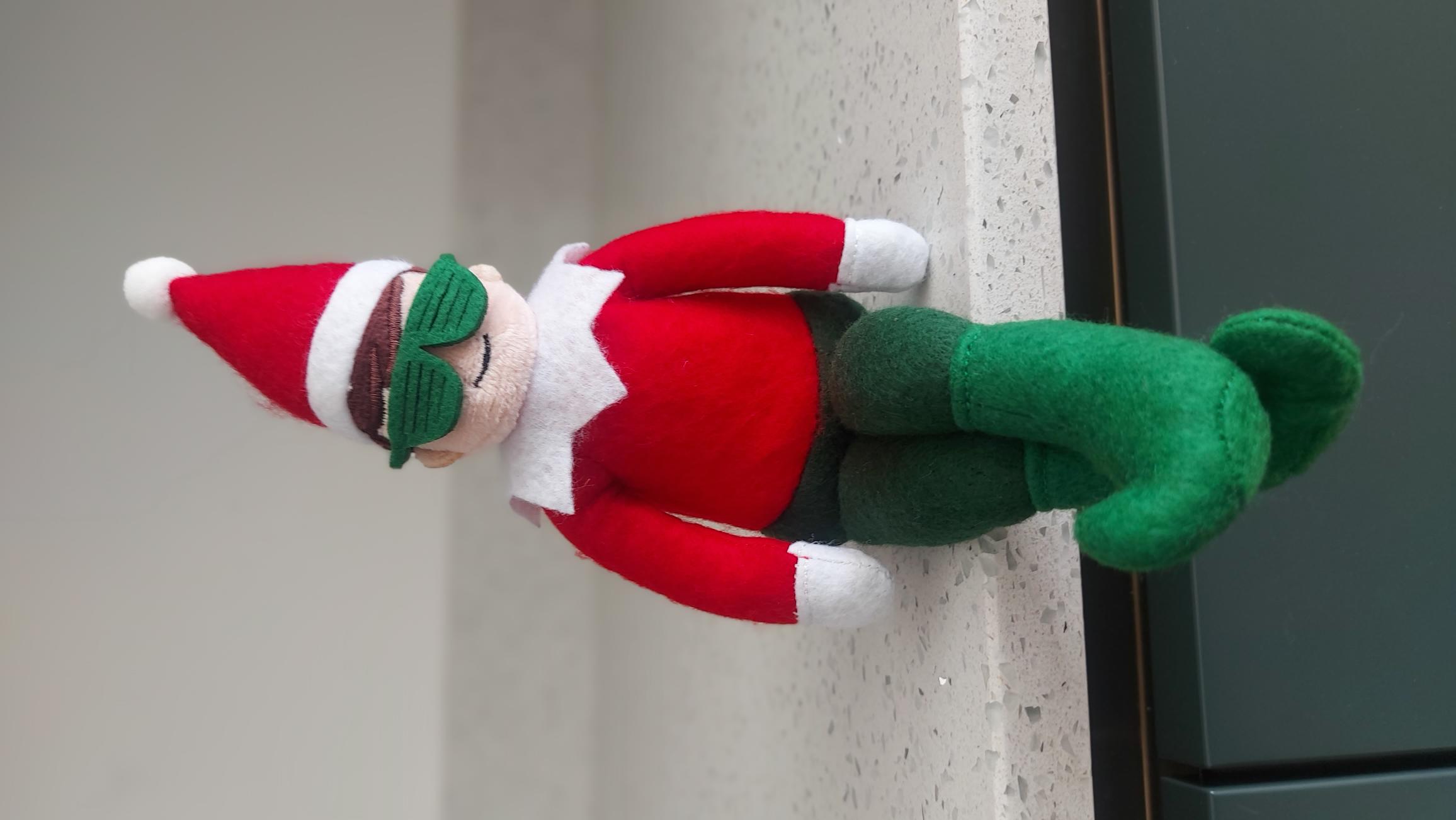 Official Cheeky Elves Jingles Doll sitting on a shelf